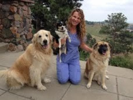 Lori with her golden retriever Ozzy and her rescue dogs Toby and Olivia